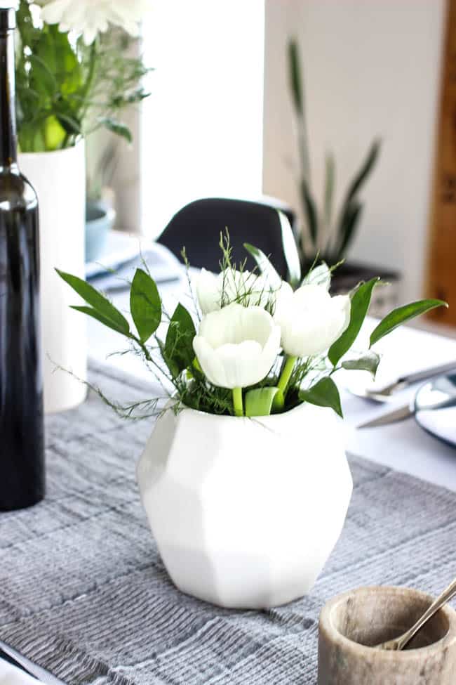 A pretty Mother's Day Tablescape. Love the earthy colours in this black, white, blue and green table setting! Beautiful floral centrepieces and modern place settings will make for the perfect spring event!