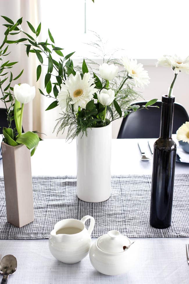 A pretty Mother's Day Tablescape. Love the earthy colours in this black, white, blue and green table setting! Beautiful floral centrepieces and modern place settings will make for the perfect spring event!