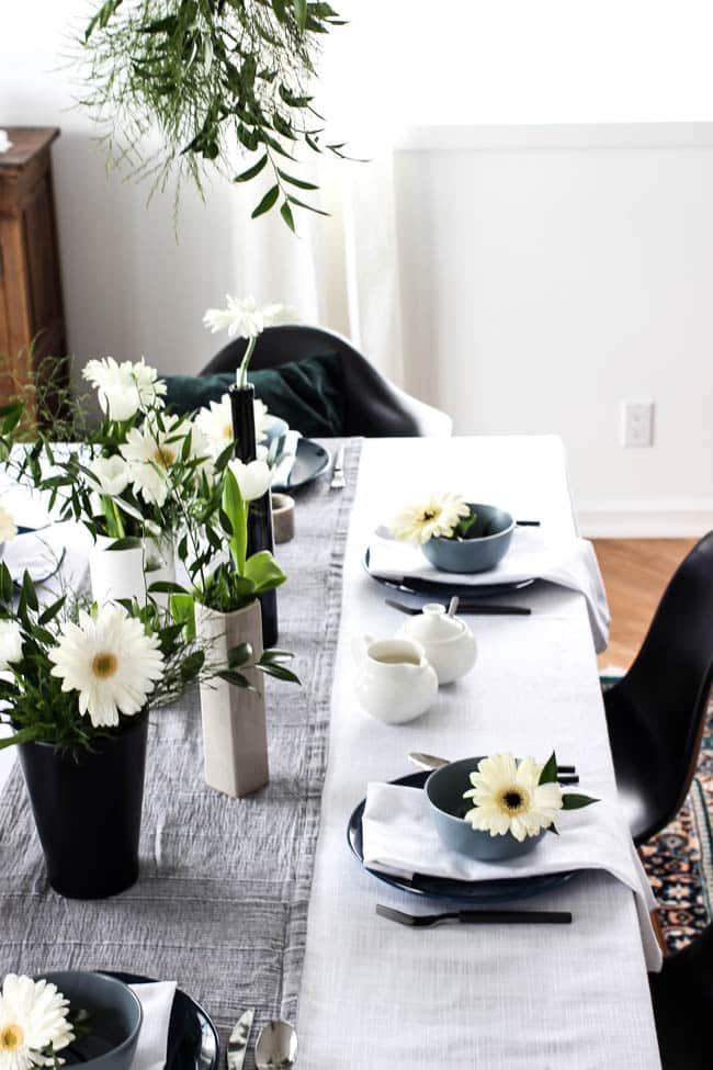 A pretty Mother's Day Tablescape. Love the earthy colours in this black, white, blue and green table setting! Beautiful floral centrepieces and modern place settings will make for the perfect spring event!