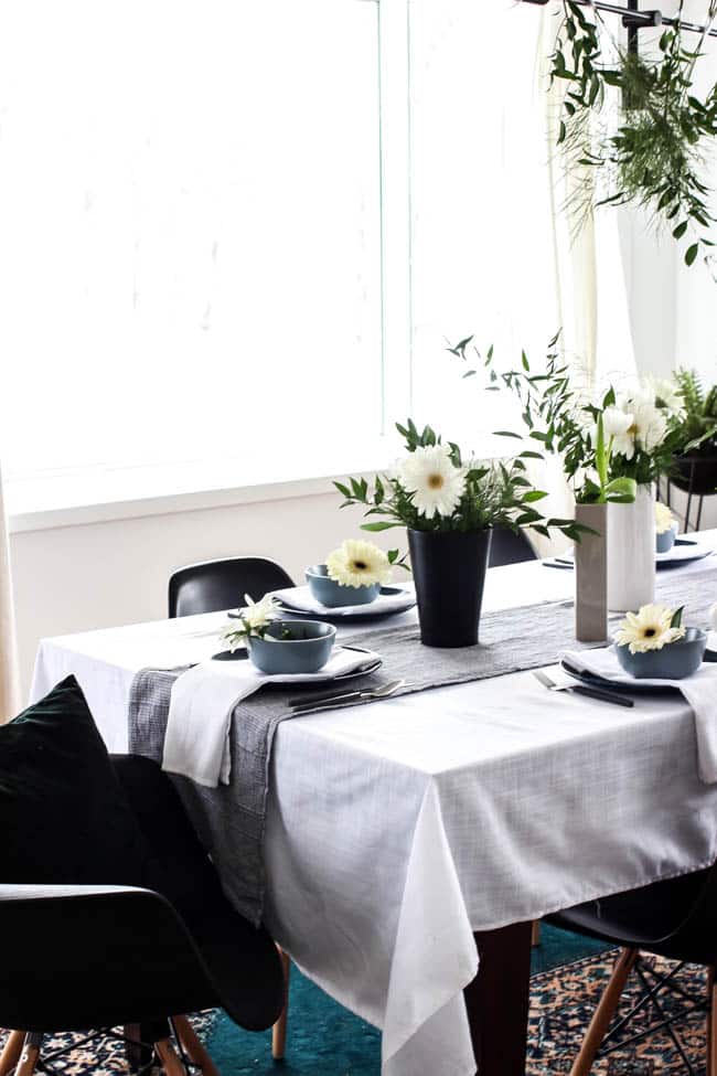 A pretty Mother's Day Tablescape. Love the earthy colours in this black, white, blue and green table setting! Beautiful floral centrepieces and modern place settings will make for the perfect spring event!