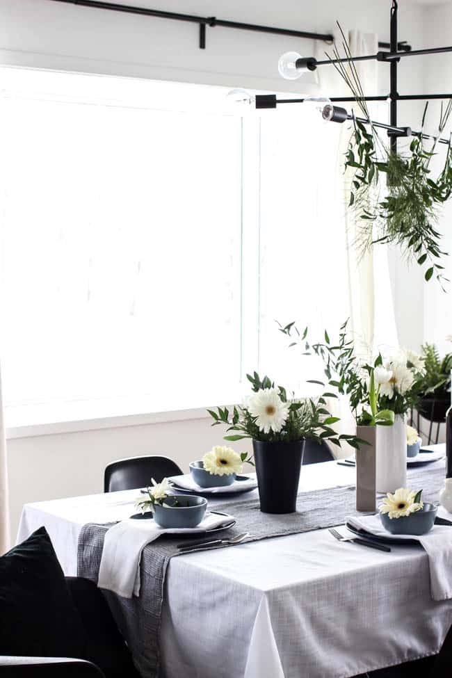 A pretty Mother's Day Tablescape. Love the earthy colours in this black, white, blue and green table setting! Beautiful floral centrepieces and modern place settings will make for the perfect spring event!