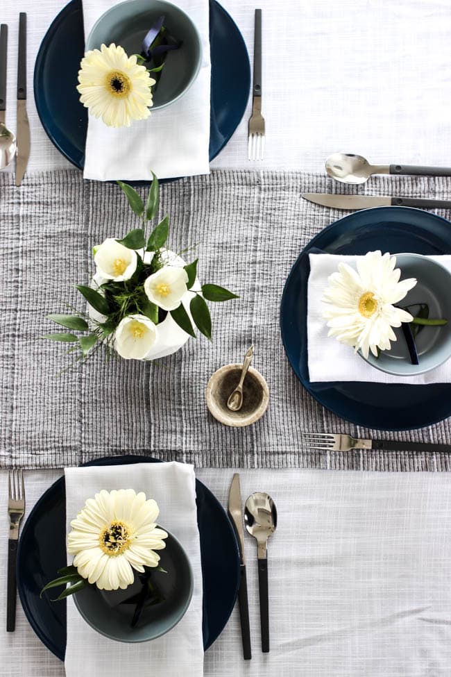 A pretty Mother's Day Tablescape. Love the earthy colours in this black, white, blue and green table setting! Beautiful floral centrepieces and modern place settings will make for the perfect spring event!