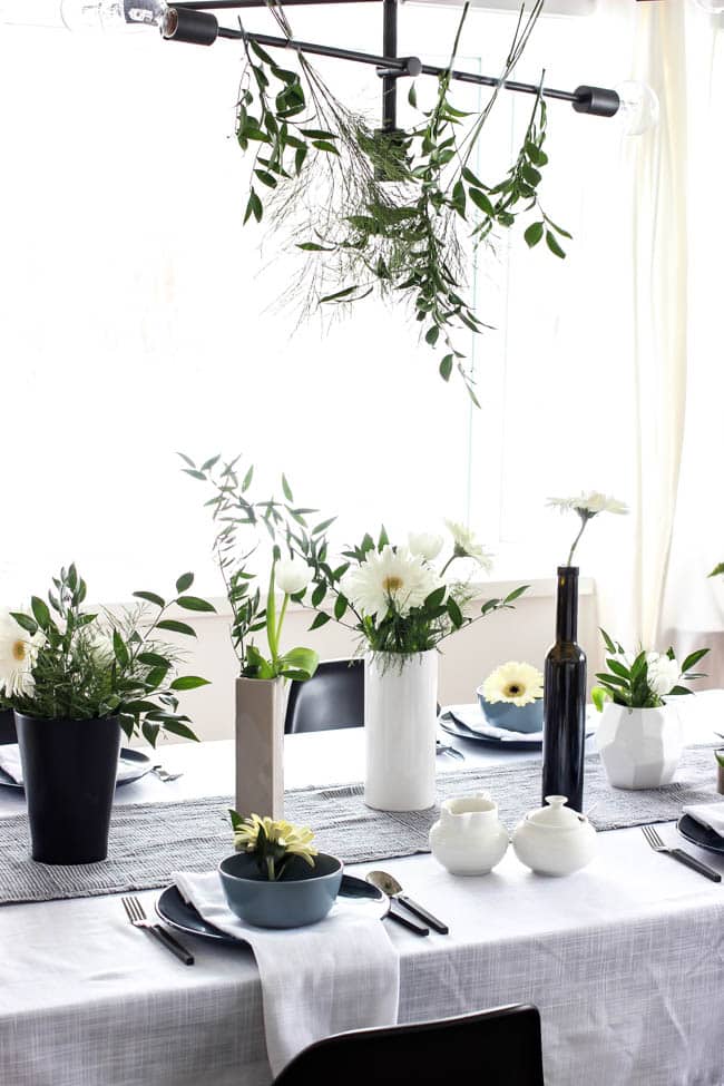 A pretty Mother's Day Tablescape. Love the earthy colours in this black, white, blue and green table setting! Beautiful floral centrepieces and modern place settings will make for the perfect spring event!