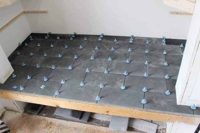 Gorgeous Tiled Entry Bench! Love the use of tile on this creative DIY project! The basalt tile looks amazing on this tiled bench seat. Great modern design for a tiled entryway!