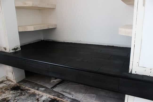 Gorgeous Tiled Entry Bench! Love the use of tile on this creative DIY project! The basalt tile looks amazing on this tiled bench seat. Great modern design for a tiled entryway!