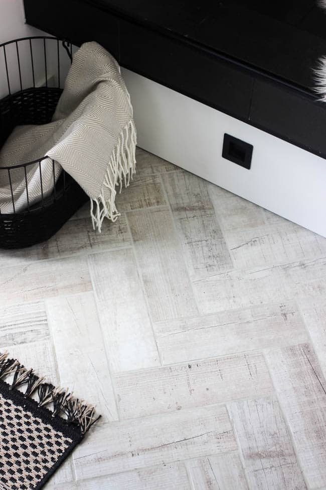 This faux wood flooring tile is a touch of rustic in our otherwise modern entryway makeover