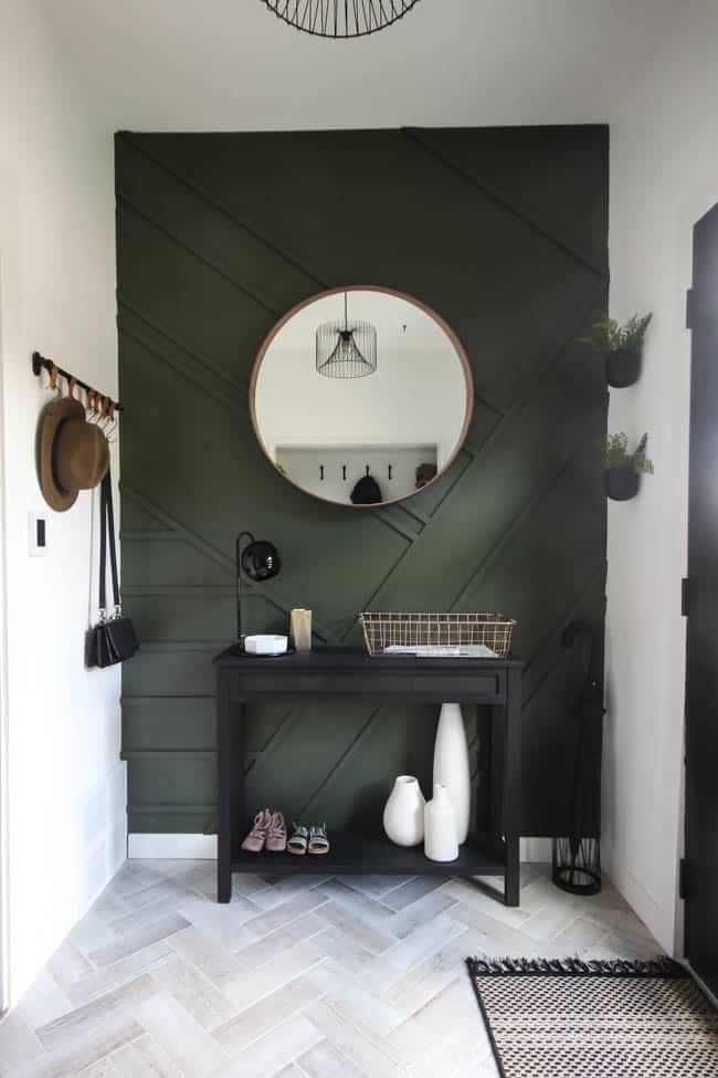 This circular mirror is the focal point on this modern style wall in our entry way