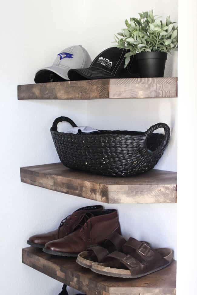 Love these rustic wood shelves in this modern style entryway