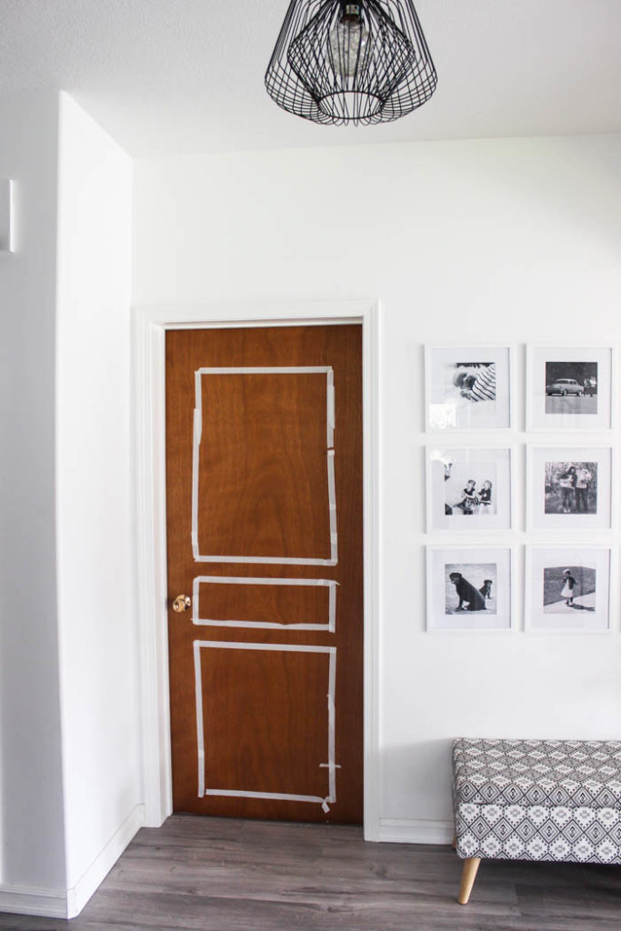 Hallway door shown before being renovated, with masking tape showing approximately where the trim will be installed