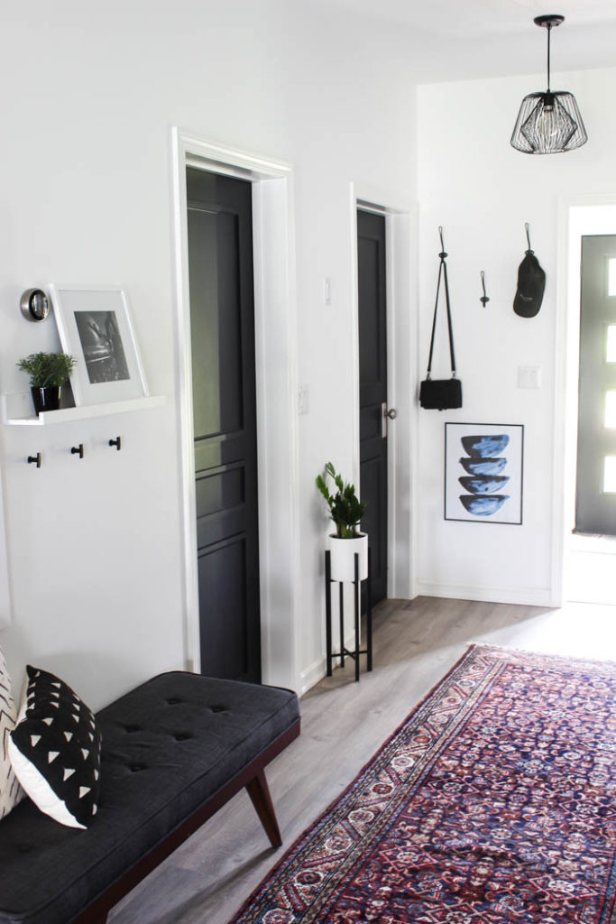 Stunning transformation! Transform outdated doors on a budget! Some trim, paint, and new hardware is all it takes to create a new modern interior door design! Love the navy blue colour on these hallway doors.