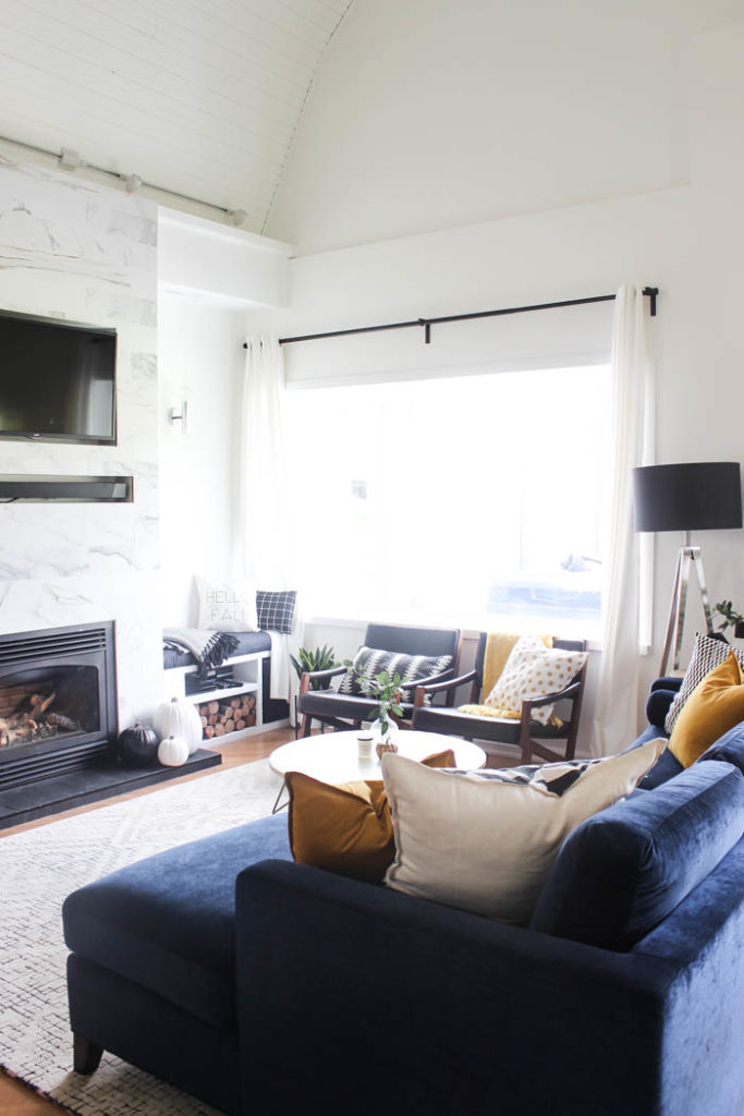 A beautiful cozy fall home tour! Love the pops of mustard yellow in this monochromatic modern fall living room! Beautiful minimalistic way to style a living room for autumn! 