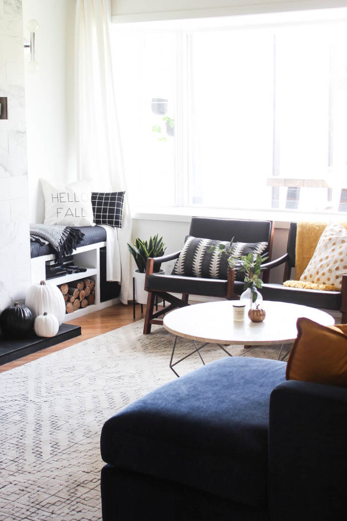 A beautiful cozy fall home tour! Love the pops of mustard yellow in this monochromatic modern fall living room! Beautiful minimalistic way to style a living room for autumn! 