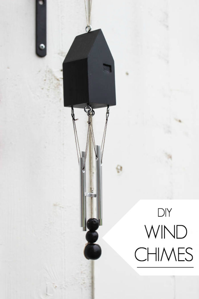 Beautiful modern wind chimes! Add beautiful decor to your outdoor space or deck with this simple thrift store update! Love the miniature houses and the stylish new take on wind chimes!