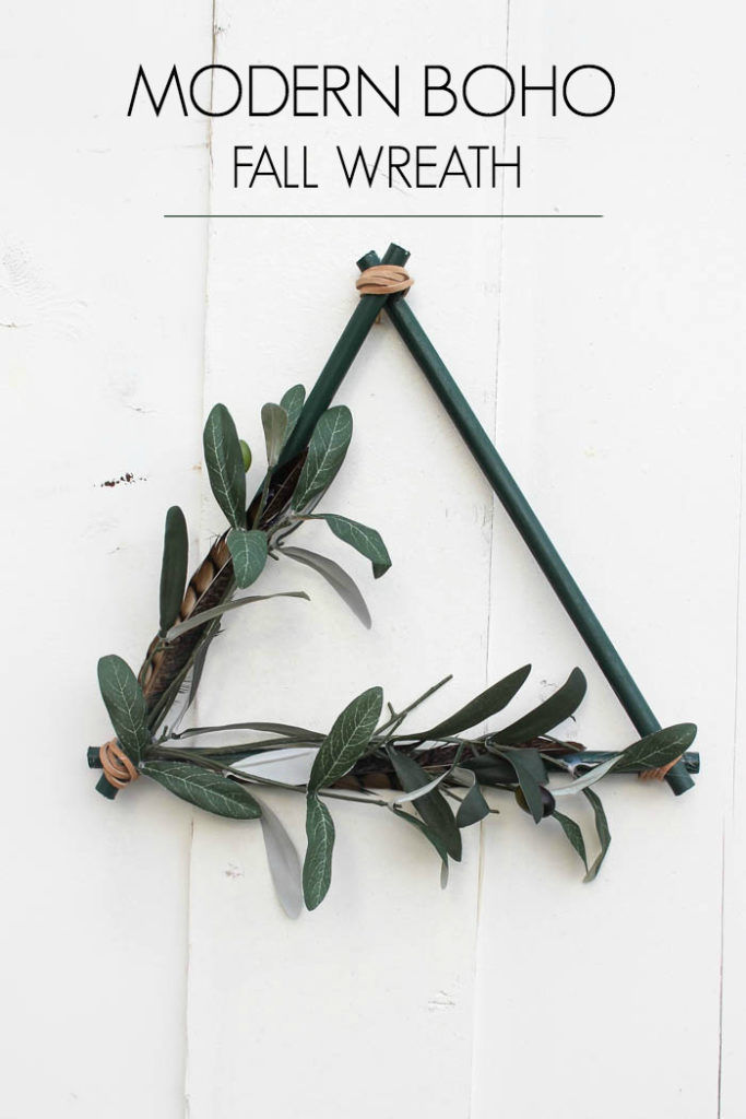 A beautiful non-traditional wreath! Love the look of this triangular modern boho wreath. Such a beautiful DIY project for the autumn season. The addition of leather, feathers, and greenery are perfect for this minimalist wreath. Beautiful greens and browns for wall!