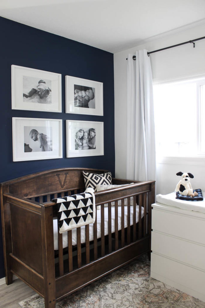 Beautiful ideas for a small nursery! This tiny baby room is off to the side of the master bedroom. Love the simple decor, from the navy wall to the brown crib and the beautiful gallery wall!