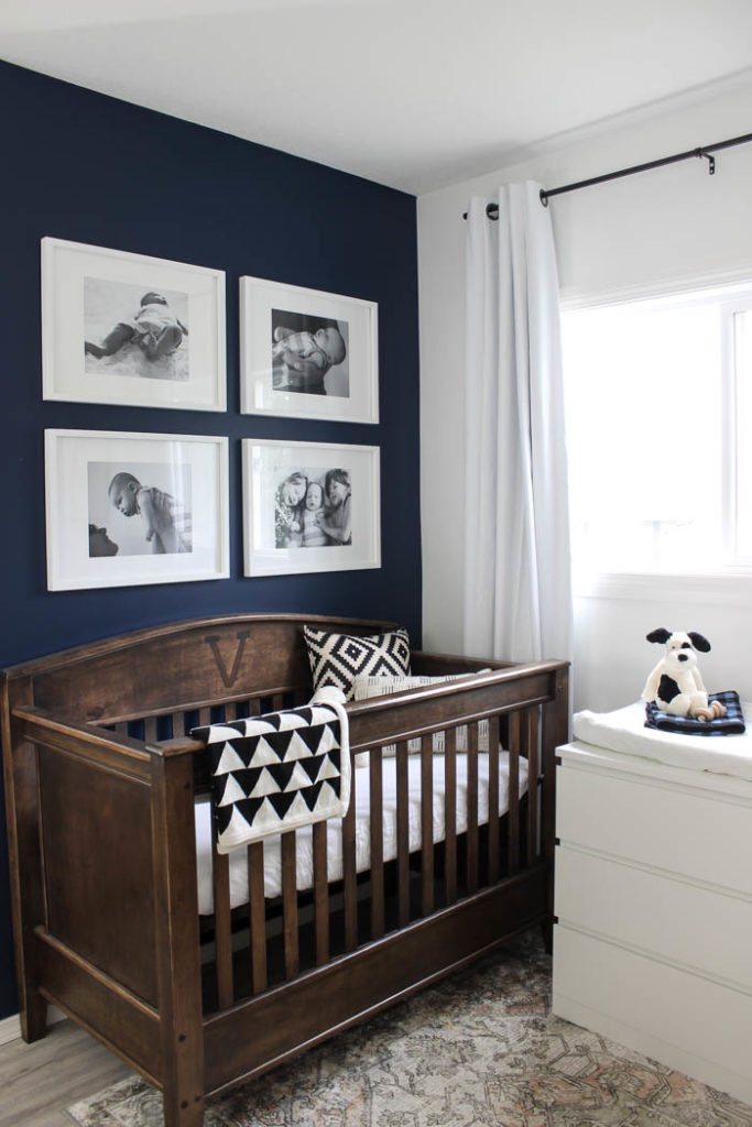 Beautiful ideas for a small modern nursery! This tiny baby room is off to the side of the master bedroom. Love the simple decor, from the navy wall to the brown crib and the beautiful gallery wall!