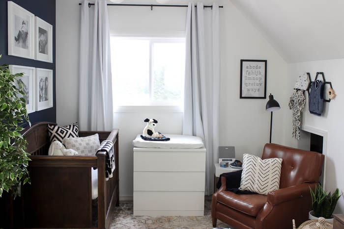 Beautiful ideas for a small modern nursery! This tiny baby room is off to the side of the master bedroom. Love the simple decor, from the navy wall to the brown crib and the beautiful gallery wall!