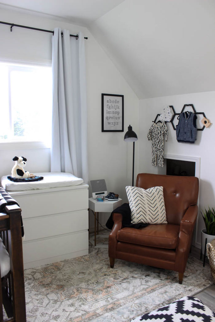 Beautiful ideas for a small modern nursery! This tiny baby room is off to the side of the master bedroom. Love the simple decor, from the navy wall to the brown crib and the beautiful gallery wall!