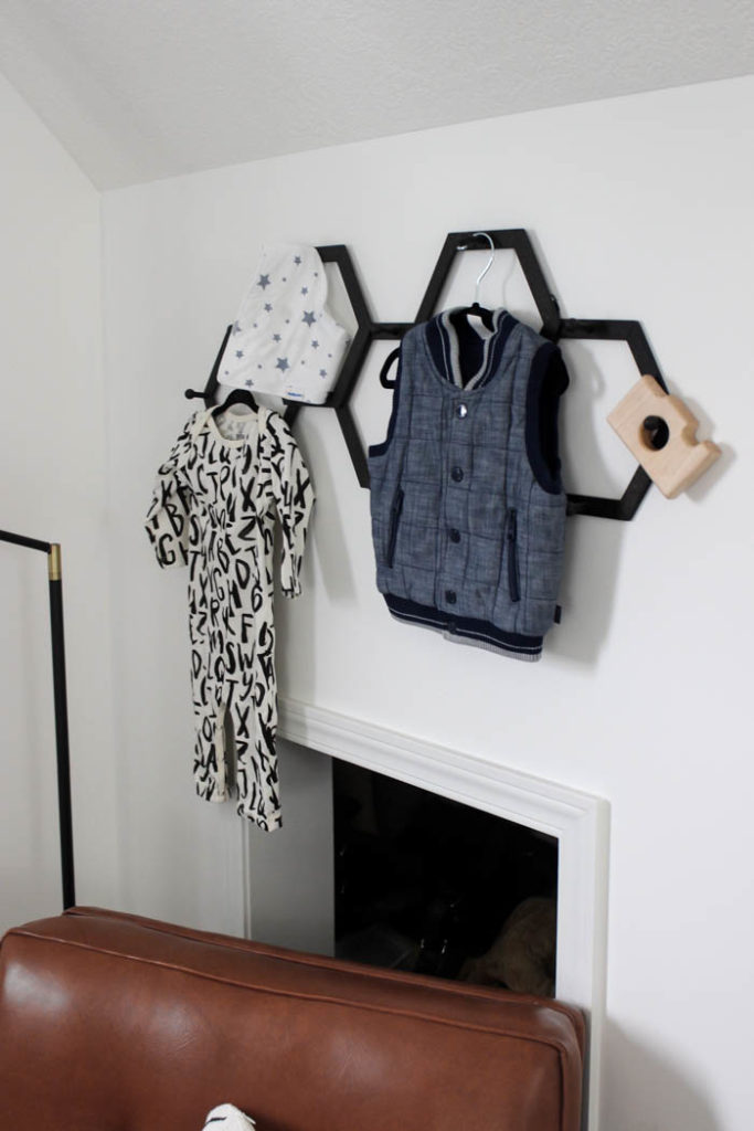 Beautiful ideas for a small modern nursery! This tiny baby room is off to the side of the master bedroom. Love the simple decor, from the navy wall to the brown crib and the beautiful gallery wall!