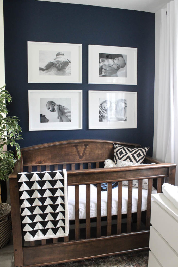 Beautiful ideas for a small modern nursery! This tiny baby room is off to the side of the master bedroom. Love the simple decor, from the navy wall to the brown crib and the beautiful gallery wall!