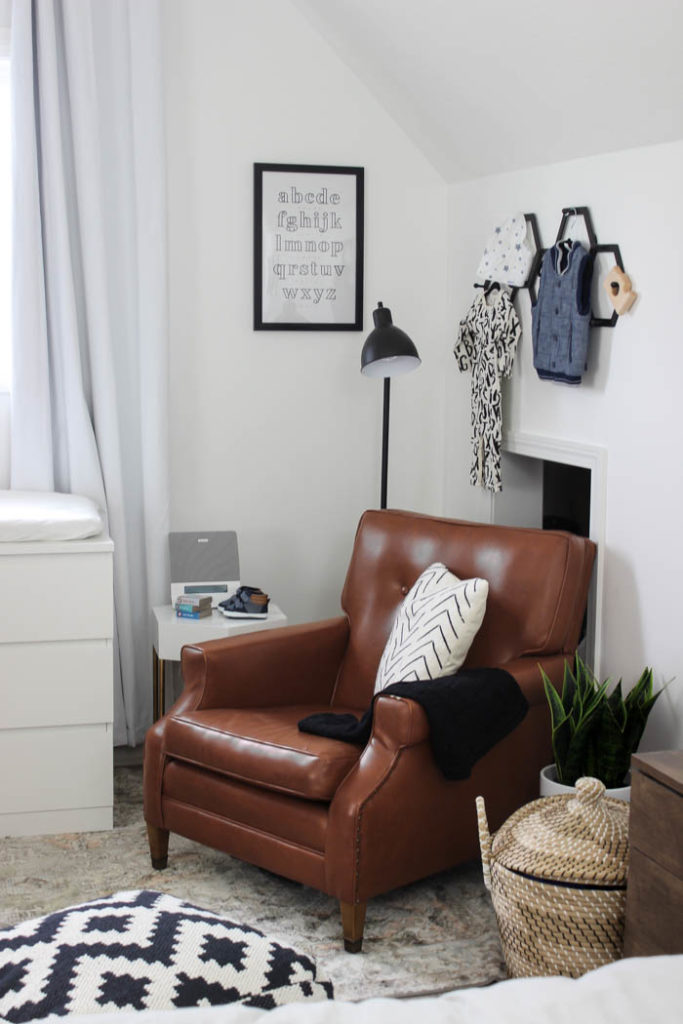 Beautiful ideas for a small modern nursery! This tiny baby room is off to the side of the master bedroom. Love the simple decor, from the navy wall to the brown crib and the beautiful gallery wall!