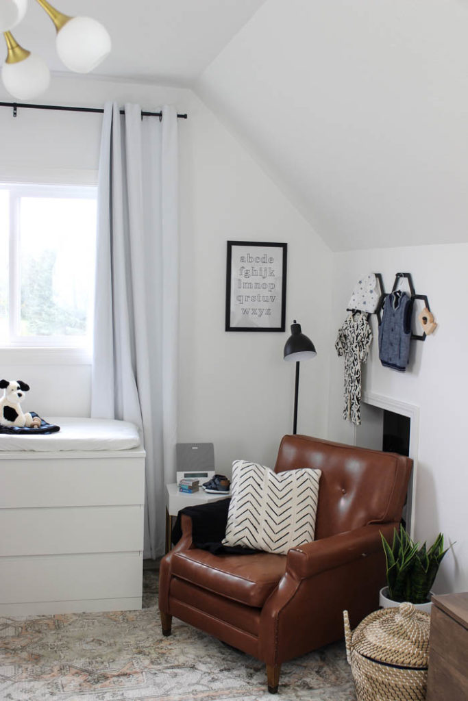 Beautiful ideas for a small modern nursery! This tiny baby room is off to the side of the master bedroom. Love the simple decor, from the navy wall to the brown crib and the beautiful gallery wall!