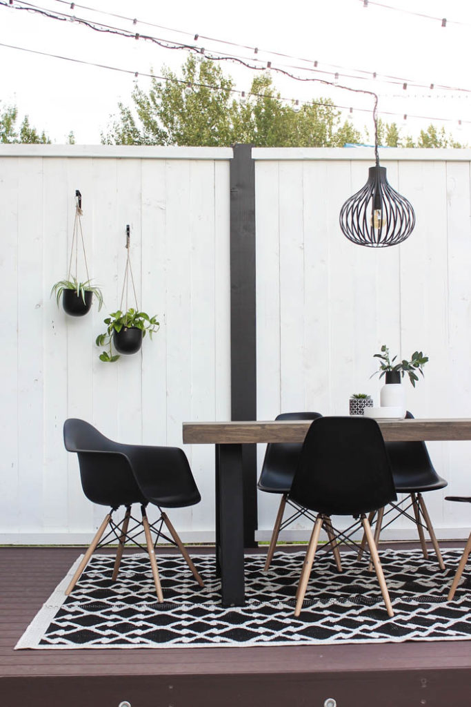 Wow! A beautiful modern outdoor space! The modern table from Article is a stunning addition to this outdoor deck. Finished off with a stunning black and white privacy wall and the gorgeous string lighting! 