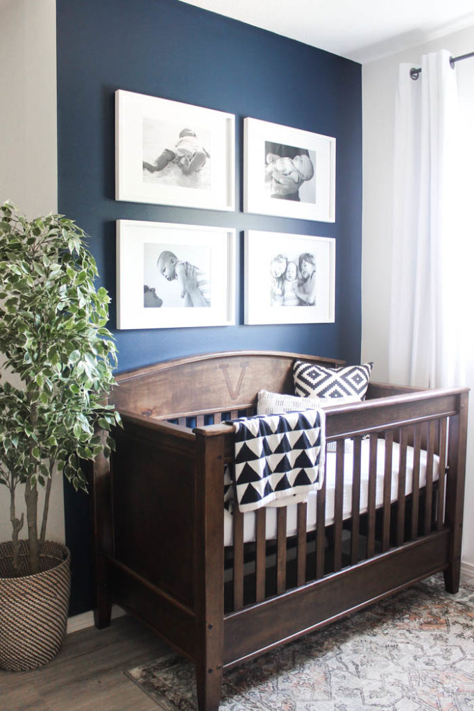 Beautiful ideas for a small modern nursery! This tiny baby room is off to the side of the master bedroom. Love the simple decor, from the navy wall to the brown crib and the beautiful gallery wall!