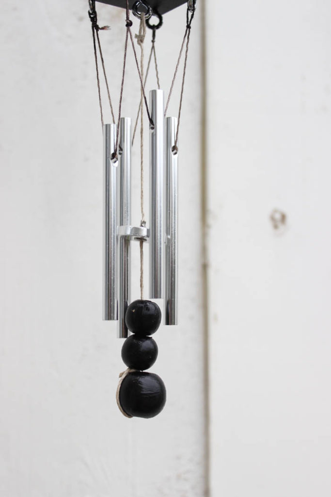 Beautiful modern wind chimes! Add beautiful decor to your outdoor space or deck with this simple thrift store update! Love the miniature houses and the stylish new take on wind chimes! 
