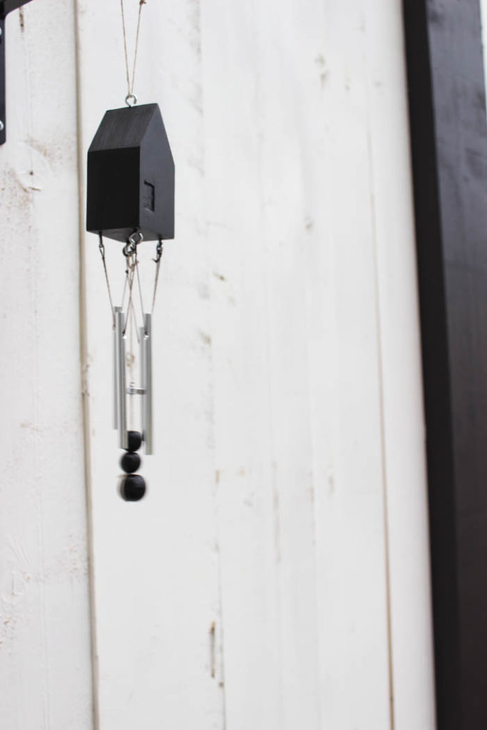 Beautiful modern wind chimes! Add beautiful decor to your outdoor space or deck with this simple thrift store update! Love the miniature houses and the stylish new take on wind chimes! 