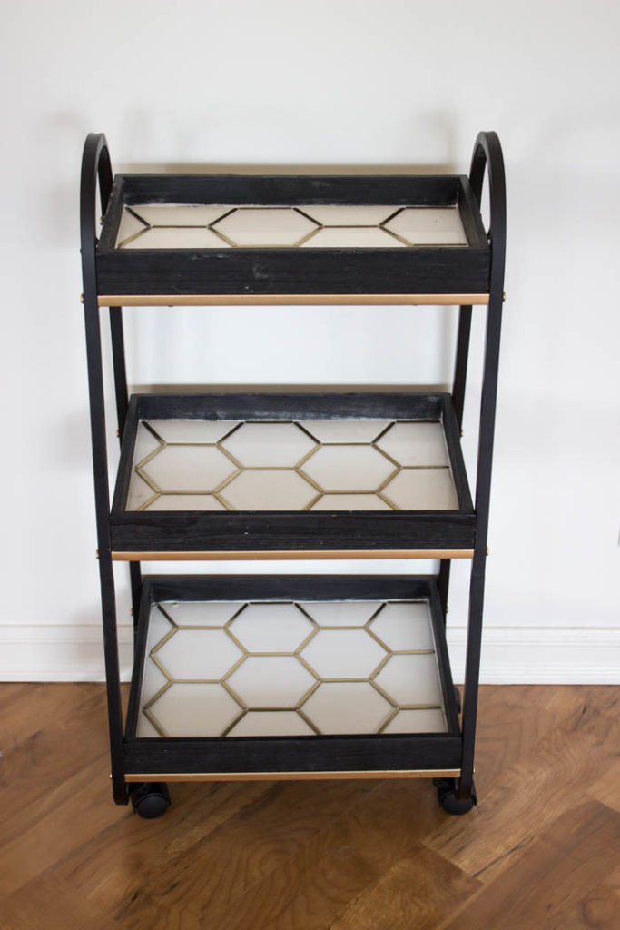 This modern bar cart is stunning! It's hard to believe that this is a DIY! Love the tile inlays and the mix of black, white, and gold in the design. Beautiful bar cart styling and ideas for your home entertaining! #DIY #barcart #tile #luxe #modern