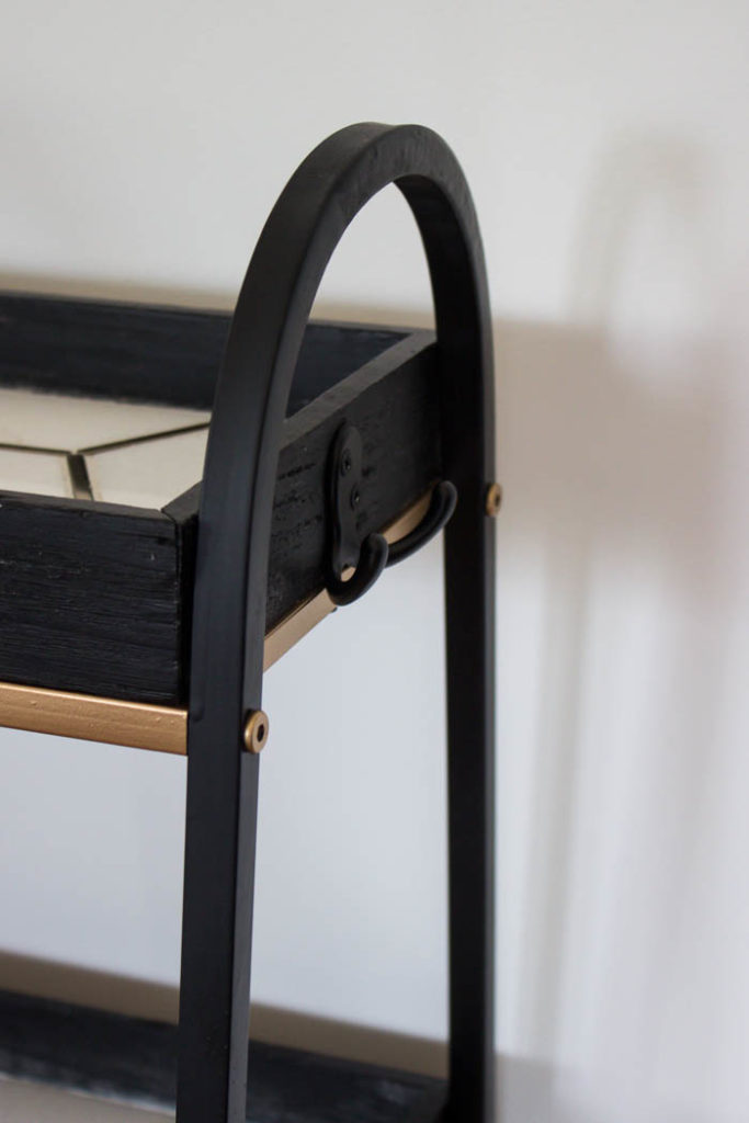 This modern bar cart is stunning! It's hard to believe that this is a DIY! Love the tile inlays and the mix of black, white, and gold in the design. Beautiful bar cart styling and ideas for your home entertaining! #DIY #barcart #tile #luxe #modern