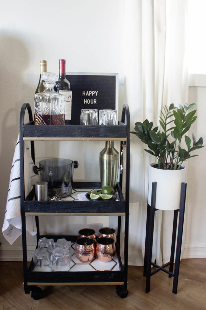 This modern bar cart is stunning! It's hard to believe that this is a DIY! Love the tile inlays and the mix of black, white, and gold in the design. Beautiful bar cart styling and ideas for your home entertaining! #DIY #barcart #tile #luxe #modern