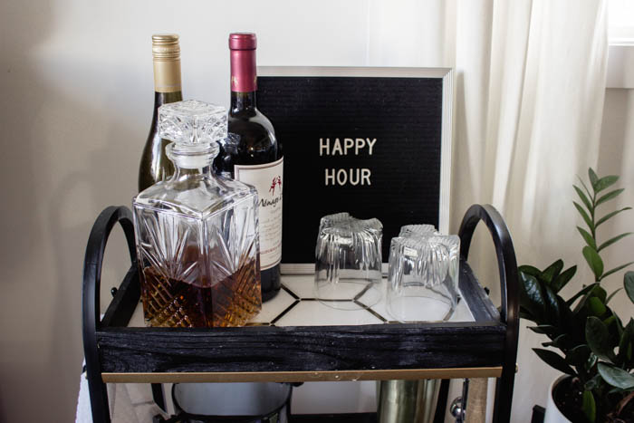 This modern bar cart is stunning! It's hard to believe that this is a DIY! Love the tile inlays and the mix of black, white, and gold in the design. Beautiful bar cart styling and ideas for your home entertaining! #DIY #barcart #tile #luxe #modern