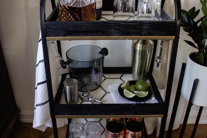 This modern bar cart is stunning! It's hard to believe that this is a DIY! Love the tile inlays and the mix of black, white, and gold in the design. Beautiful bar cart styling and ideas for your home entertaining! #DIY #barcart #tile #luxe #modern