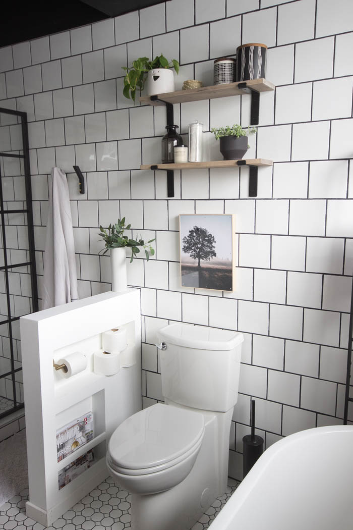 Shelves over the toilet in the modern bathroom.