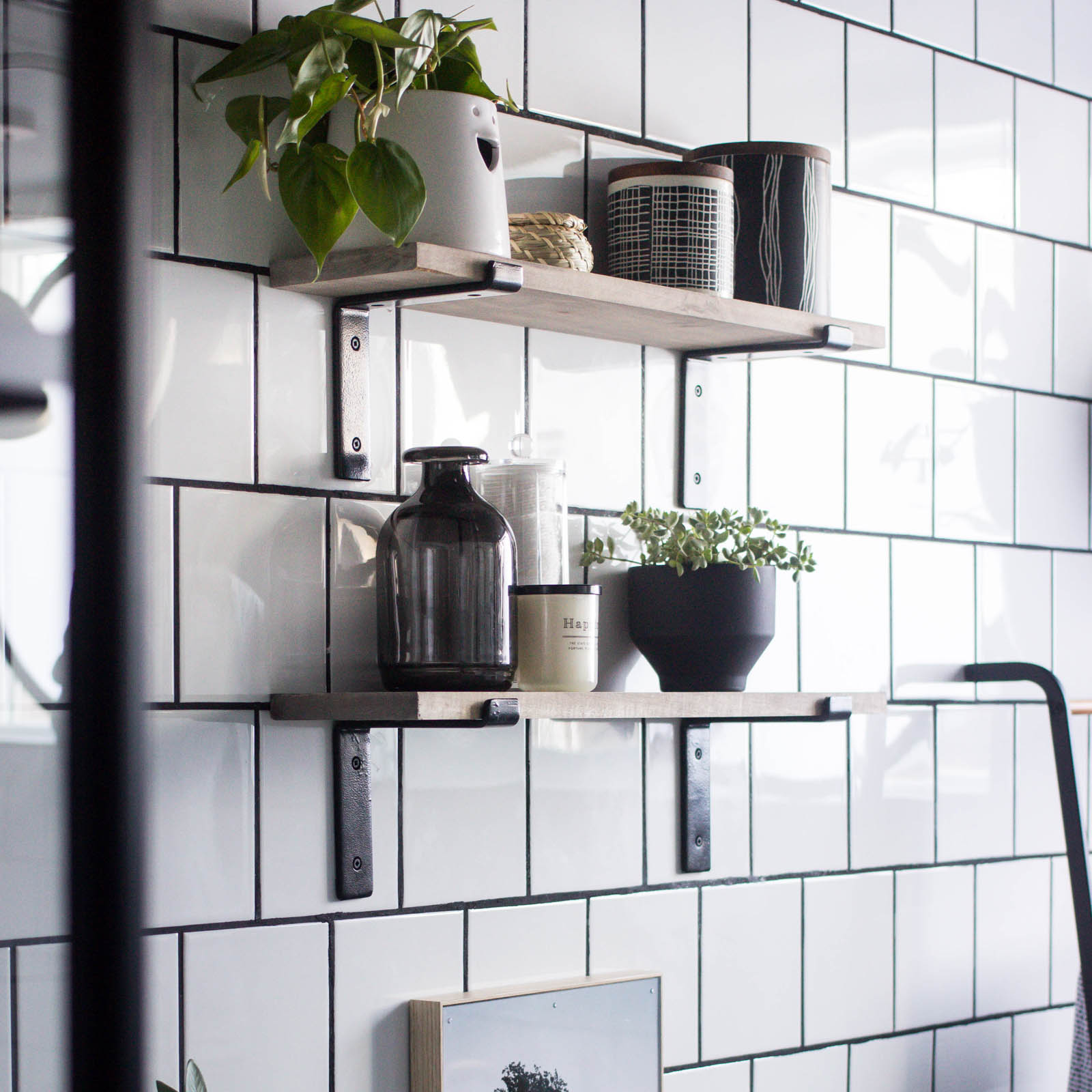 Love the look of this simple bathroom shelving! The open shelving is beautiful and so easy to build! Get tips and tricks for drilling into tile too! Love the modern bathroom design. #moderndesign #bathroom #DIY