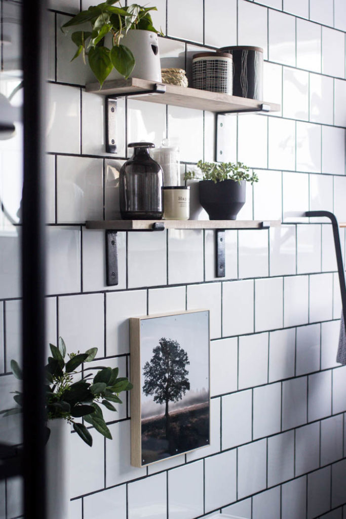 Love the look of this simple bathroom shelving! The open shelving is beautiful and so easy to build! Get tips and tricks for drilling into tile too! Love the modern bathroom design. #moderndesign #bathroom #DIY