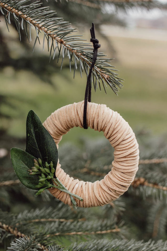 Beautiful mini wreath ornaments! These stylish leather ornaments are the perfect holiday accessory! Decorate your tree with this simple DIY Christmas craft! Perfect for modern, farmhouse, traditional, or any decor style! #Christmascraft #christmas #modernChristmas #holidaydecor #wreath