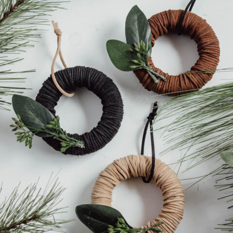 Beautiful mini wreath ornaments! These stylish leather ornaments are the perfect holiday accessory! Decorate your tree with this simple DIY Christmas craft! Perfect for modern, farmhouse, traditional, or any decor style! #Christmascraft #christmas #modernChristmas #holidaydecor #wreath