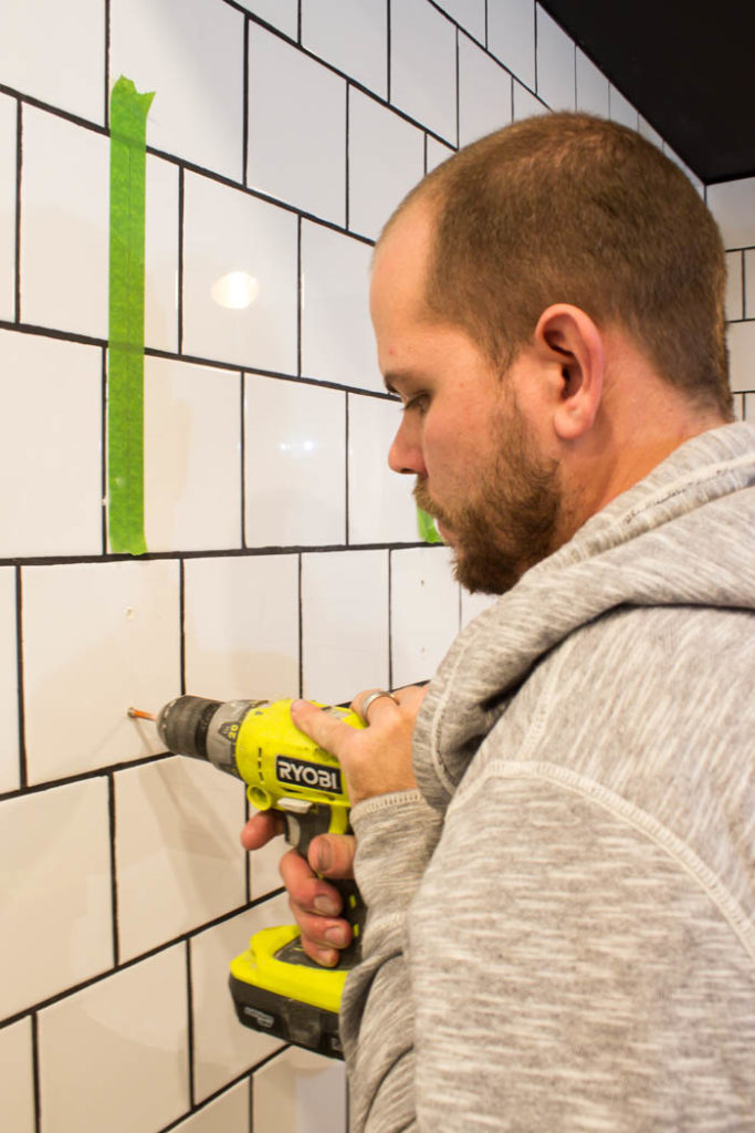 Love the look of this simple bathroom shelving! The open shelving is beautiful and so easy to build! Get tips and tricks for drilling into tile too! Love the modern bathroom design. #moderndesign #bathroom #DIY 