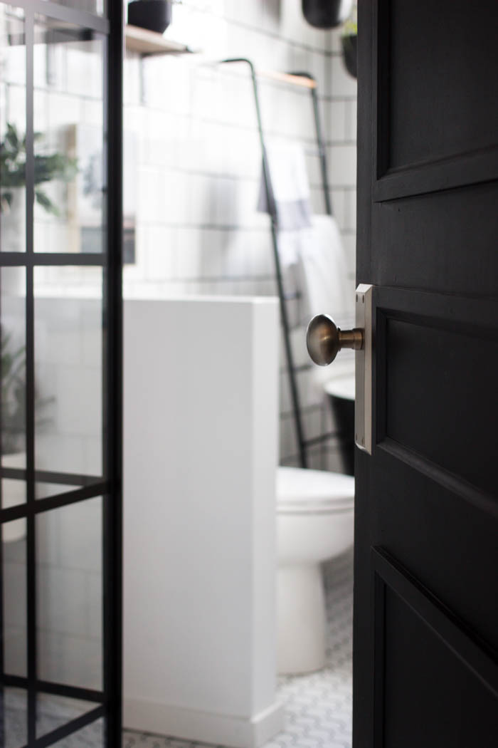 Door opening to reveal the modern bathroom.