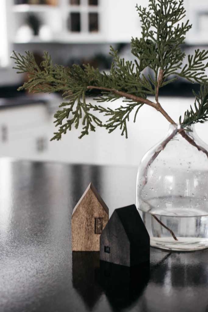 A Modern Minimalist Christmas Kitchen and Dining Room! LOVE the subtle touches of Christmas and the beautiful decor in these two rooms. A beautiful mix of natural colours in the green, black, and white colour palette. Touches of nordic and scandi style in this minimalistic holiday design. #nordic #modern #Christmas #Christmasdecor #ChristmasKitchen #blackandwhite 