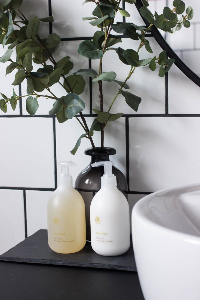 Greenery and hand soap in the modern bathroom reveal.