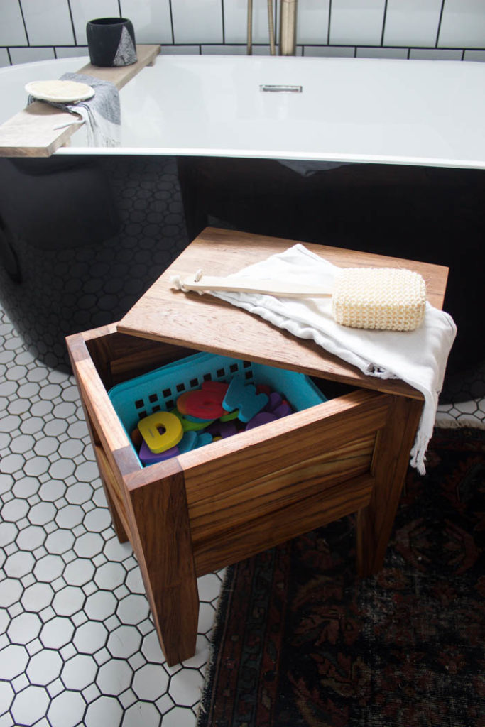 A stunning modern bathroom stool! Love the design of this teak bathroom stool. The removable lid reveals the hidden storage - a genius idea for storing your bathroom toys! The slats underneath allow the water to seep out naturally. A great bathroom idea with free build plans! #freebuildplans #modernbathroom #DIY #woodworking #teak