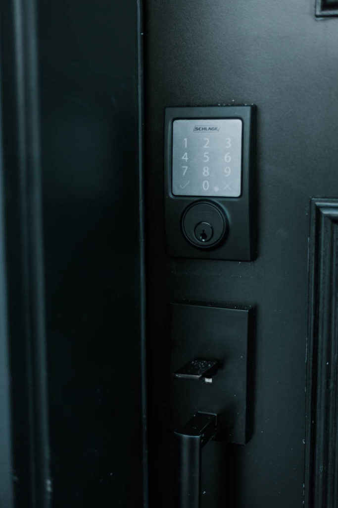Update your front door with a keyless door lock. These amazing smart locks can be controlled with an app and linked to your Google Home device. Love the matte black lock and hardware on this black door! #smarttechnology #entry #modernentry #keylessentry #hardware