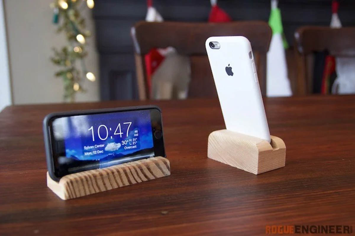 2 phones sitting in wooden phone holders