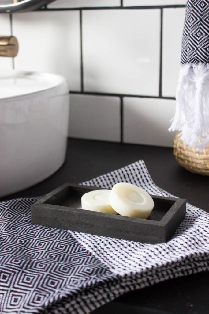 Sleek modern soap dish! Love this easy modern DIY using leftover tile! Love the chic and masculine feel to this modern DIY project on a budget. Looks amazing in this modern bathroom! #budgetfriendly #modernbathroom #basalt #leftovertile #makeover 