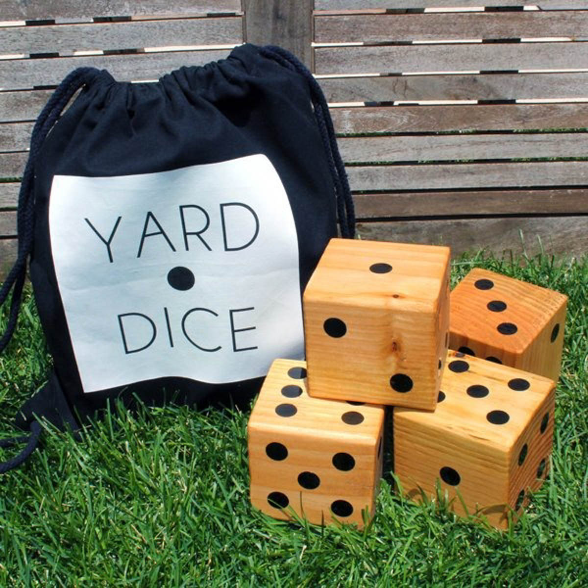 wooden yard dice sitting next to bag 
