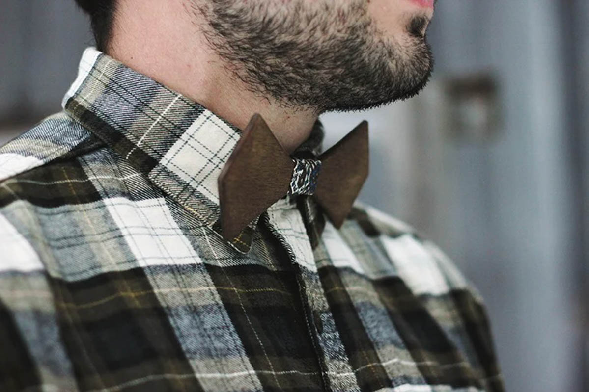 man in plaid shirt with wood bow tie